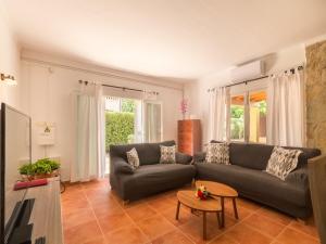 a living room with a couch and a table at Holiday Home Bona Mar with Pool in Cala Ratjada