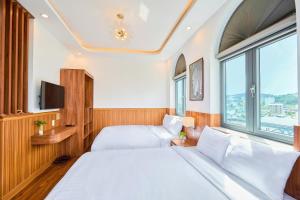 Letto o letti in una camera di Lotus Hotel Đà Lạt