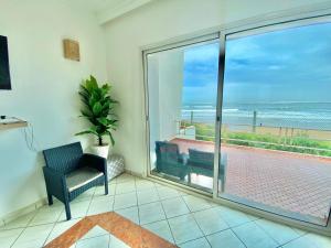 a living room with a view of the ocean at Please add me - Plus One 514 six six two 5576 - Villa Paradise Beach - Sidi Bouzid - Ocean Sunset Views & Pools in Douar Ourlali