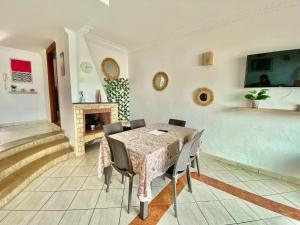 a dining room with a table and chairs and a fireplace at Please add me - Plus One 514 six six two 5576 - Villa Paradise Beach - Sidi Bouzid - Ocean Sunset Views & Pools in Douar Ourlali