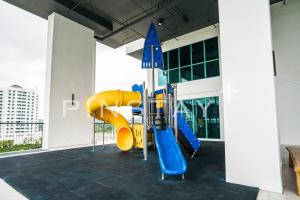 a playground in a building with a slide at Bay Suites by Pinstay Plus in Kota Kinabalu