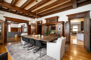 a kitchen and dining room with a wooden table and chairs at No. 5 East in Winnipeg
