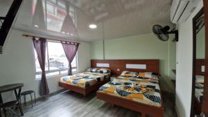 a bedroom with two beds and a window at Hotel ocaso real in Villavicencio +30 photos