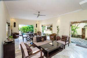 a living room with a table and chairs at Villa Diana Bali in Legian