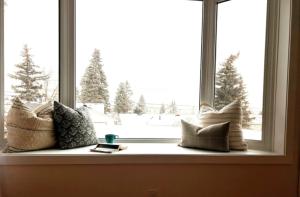 a window with pillows sitting on a window sill at Modern 3BR Near Airport & DT in Calgary