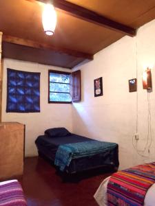 a bedroom with a bed and a window at La Guarida del Caudillo 58A in Antigua Guatemala