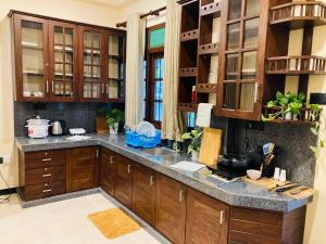 a kitchen with wooden cabinets and a granite counter top at Cinnamon Edge in Mihiripenne