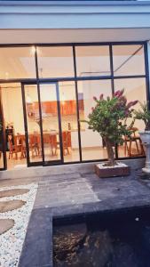 a house with a tree in the middle of a building at Aksamala Villa Echobeach Canggu in Canggu