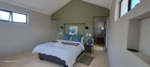 a bedroom with a large bed and a mirror at Achab chalets in Usakos