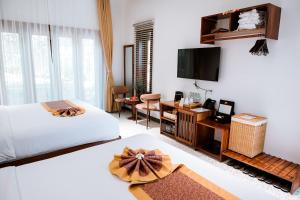 Postel nebo postele na pokoji v ubytování Pandora Sand Hill Mũi Né Resort + 219 fotografií