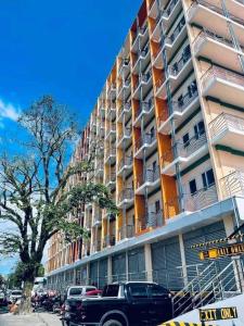 a truck parked in front of a tall building at La Joya Suite in Naga