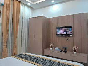 a hotel room with a tv on a wall at Residency with Banquet by KDS in Greater Noida