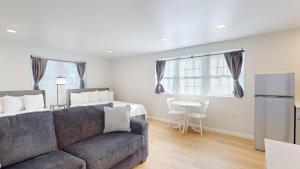 a living room with a couch and a kitchen at The Cape in Cape May