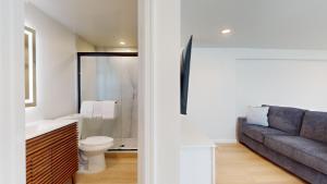 a living room with a couch and a bathroom at The Cape in Cape May