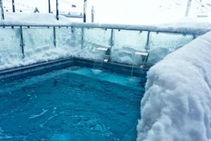 a swimming pool covered in snow and ice at Altapura in Val Thorens