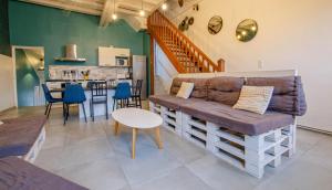 a living room with a couch and a table at La maison d'à côté in Dienville