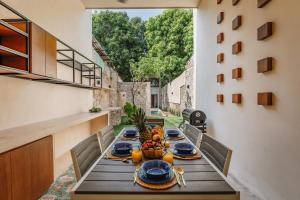 a wooden table with a bowl of fruit on it at Casa de la Ermita in Mérida