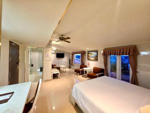 a bedroom with a bed and a living room at Tulip Hotel 3 in Da Lat