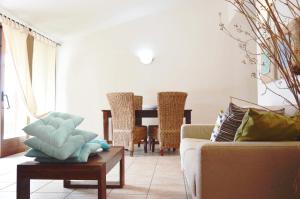 a living room with a couch and a table at Sa Tirìa in Chia