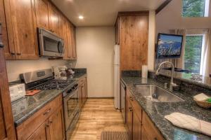 a kitchen with wooden cabinets and granite counter tops at Kingswood Cornerview home in Kings Beach