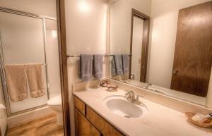 a bathroom with a sink and a toilet and a mirror at Kingswood Cornerview home in Kings Beach +12 photos
