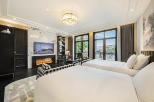 a bedroom with two beds and a fireplace at Chongqing Manque Mansion, Century Old Republic Style & River View, Free Custom Photoshoot, Free Breakfast & 131 Skydeck Ticket in Chongqing