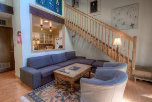a living room with a blue couch and chairs at Alpine Getaway home in Tahoe City
