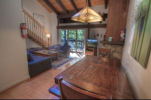 a living room with a large wooden table and a living room at Alpine Getaway home in Tahoe City