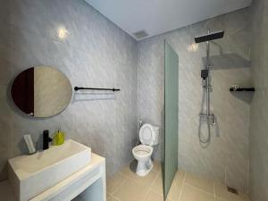 a bathroom with a sink and a toilet and a shower at PUSPA guest house in Canggu +16 photos