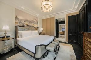a bedroom with a large white bed and a chandelier at Chongqing Manque Mansion, Century Old Republic Style & River View, Free Custom Photoshoot, Free Breakfast & 131 Skydeck Ticket in Chongqing +164 photos