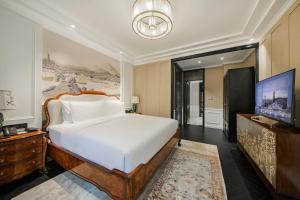 a bedroom with a large bed and a flat screen tv at Chongqing Manque Mansion, Century Old Republic Style & River View, Free Custom Photoshoot, Free Breakfast & 131 Skydeck Ticket in Chongqing