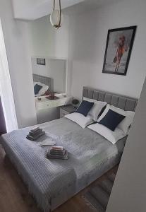 a bedroom with a large bed with blue and white pillows at Zlata Imperium Residence 12profi in Suceava