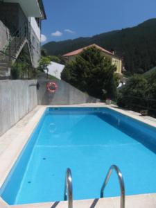 a large blue swimming pool on top of a building at Casa Marciana in Geres