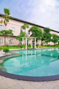 a large swimming pool in front of a building at Hotel Bonero Residence in Bojonegoro