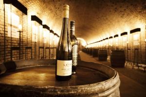 two bottles of wine sitting on top of a barrel at Alter Winzerkeller in Kirchberg am Wagram