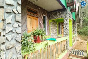 a house with a balcony with plants on it at Say Homes Glorious Holidays in Māngwa