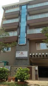 a building with a sign on the side of it at The Pride Hill-tone in Bangalore
