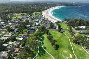 an aerial view of a golf course next to the ocean at Mariners 5 in Mollymook