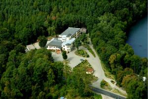 an aerial view of a large house in the forest at Hotel Dlugie in Strzelce Krajeńskie