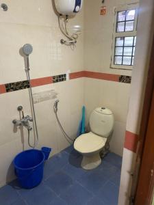 a bathroom with a toilet and a shower at stay at Chennai N4B in Chennai