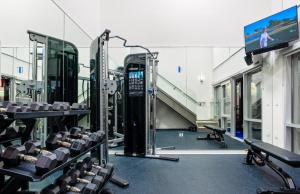 a gym with rows of tread machines and a tv at Sea & Sky 2 Bed Escape Apt in Santa Monica with FREE PARKING in Los Angeles