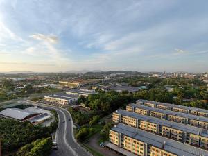 an overhead view of a city with buildings and a road at Near Airport K Avenue Homestay by MINO Suites in Donggongon