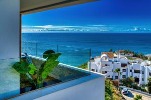 a balcony with a view of the ocean at New sunset views in Torrox Costa