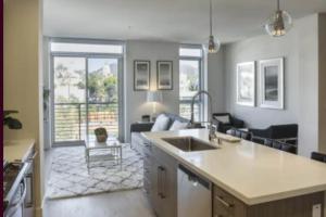 a living room with a kitchen and a living room with a couch at A-Class Highland 2 Bed Apt in Hollywood CA with FREE PARKING in Los Angeles