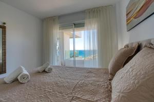 a bedroom with a large bed with towels on it at New sunset views in Torrox Costa