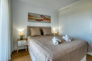 a bedroom with a bed with towels on it at New sunset views in Torrox Costa +33 photos