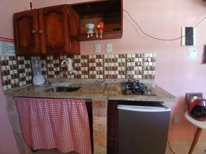 a kitchen with a sink and a counter top at Mini casa pé na areia in Ilhéus