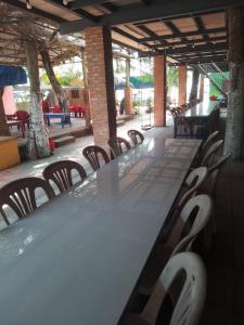a long table and chairs in an outdoor patio at Vườn Dừa Cam Bình 1 in La Gi