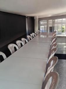a conference room with a long table and chairs at Vườn Dừa Cam Bình 1 in La Gi