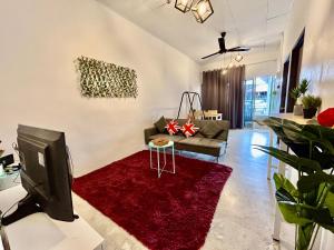 a living room with a tv and a red rug at Home41#6pax#netflix#NearIconCity&AeonAlma in Bukit Mertajam